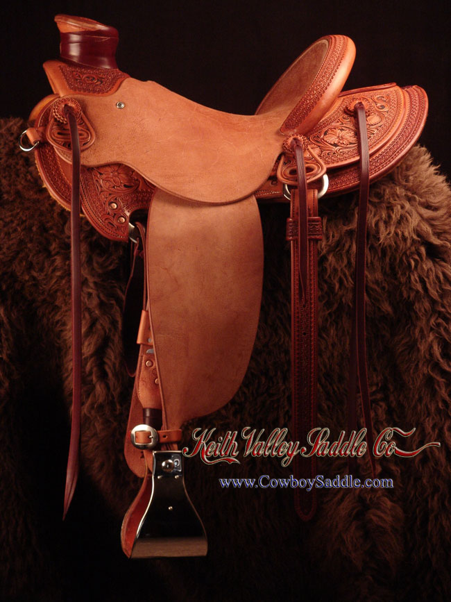 Douglas 38 Wade - tree, 15 and 1/4 inch seat, Gullet - 7 and 1/2 inch by 6 and 1/4 inch by 4 inch, Horn  3 inch round, 90 degree bars, 7/8ths flat palte riggin, Cheyenne Roll, Sheridan Style Floral Carving bordered with Vaquero Lace original design by Keith Valley.